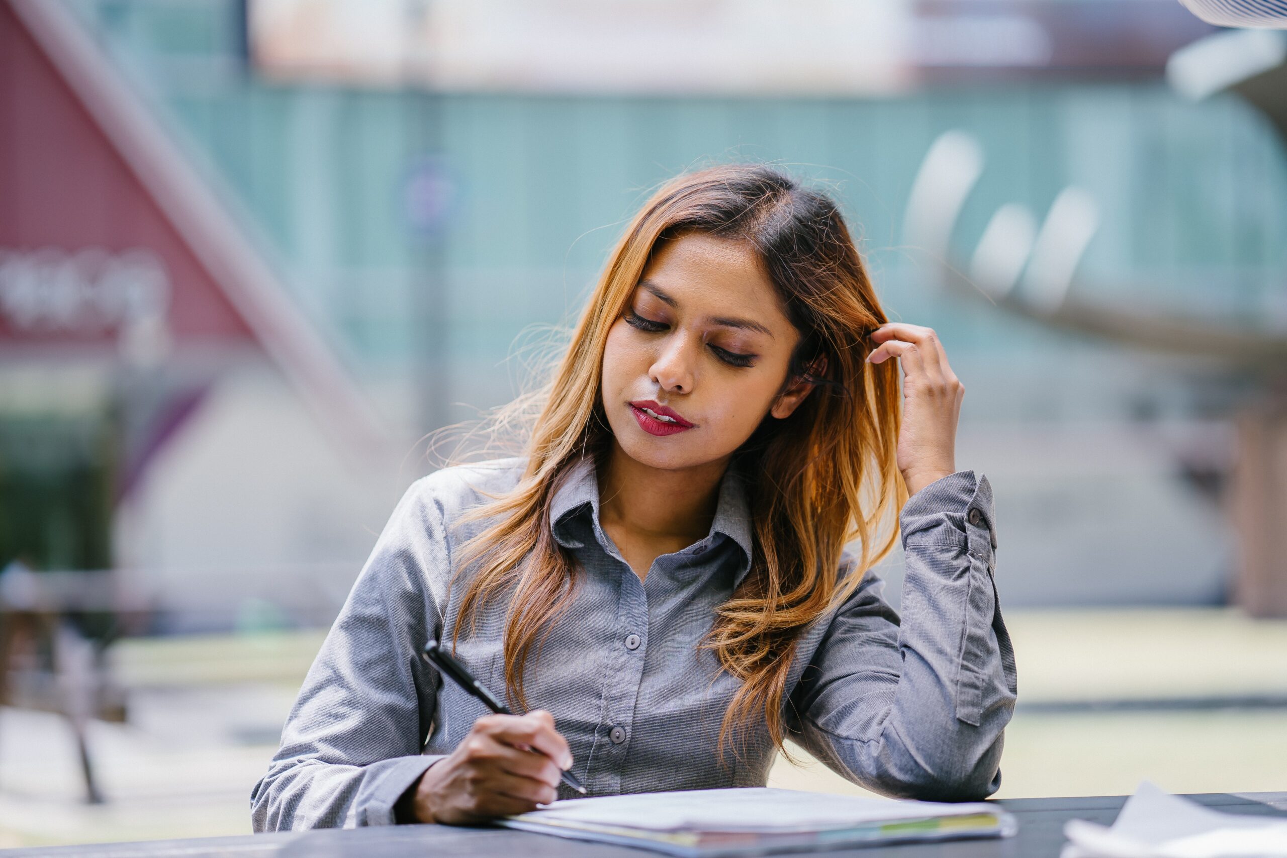 sitting-woman-reading-and-holding-pen-2029796